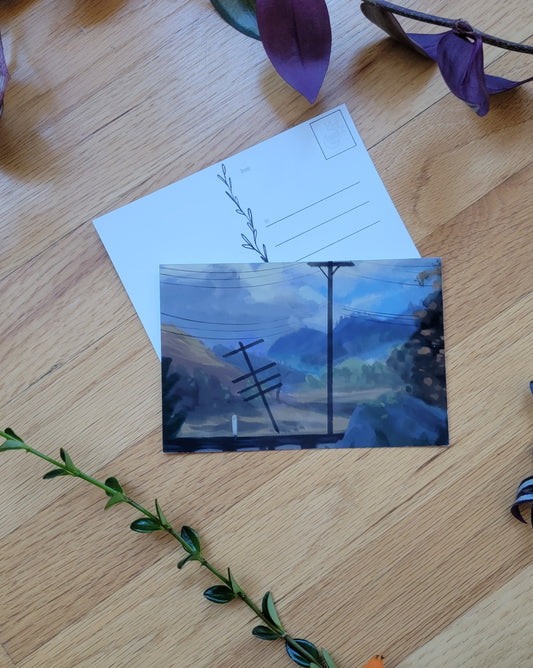 a photo of two post cards, one overlapping the other. Plants frame the image.