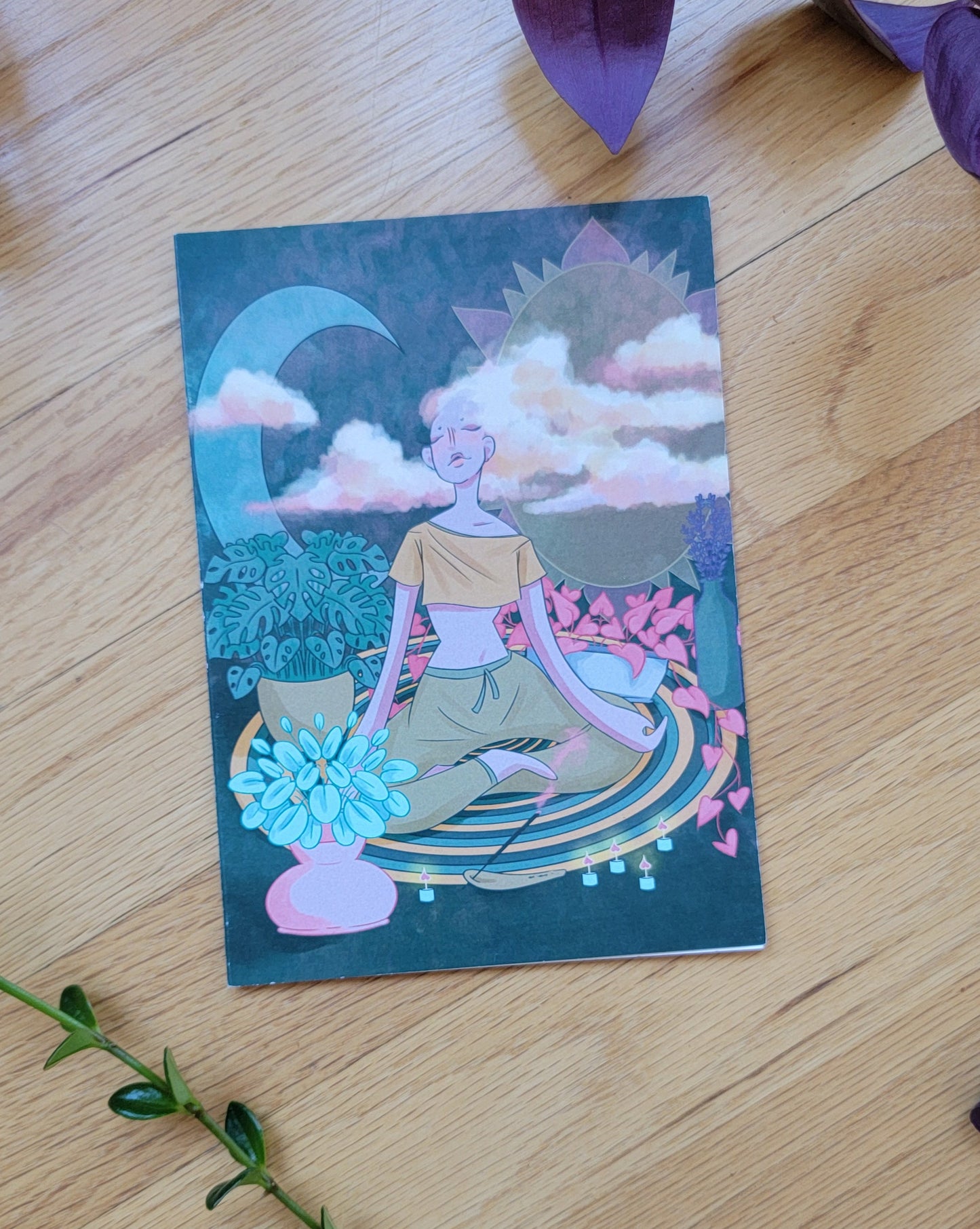 some plants frame a greeting card, laying closed so the front is visible.