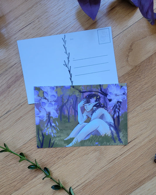 a photo of two post cards, one overlapping the other. Plants frame the image.